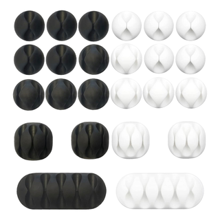 Set of black and white adhesive cord management clips
