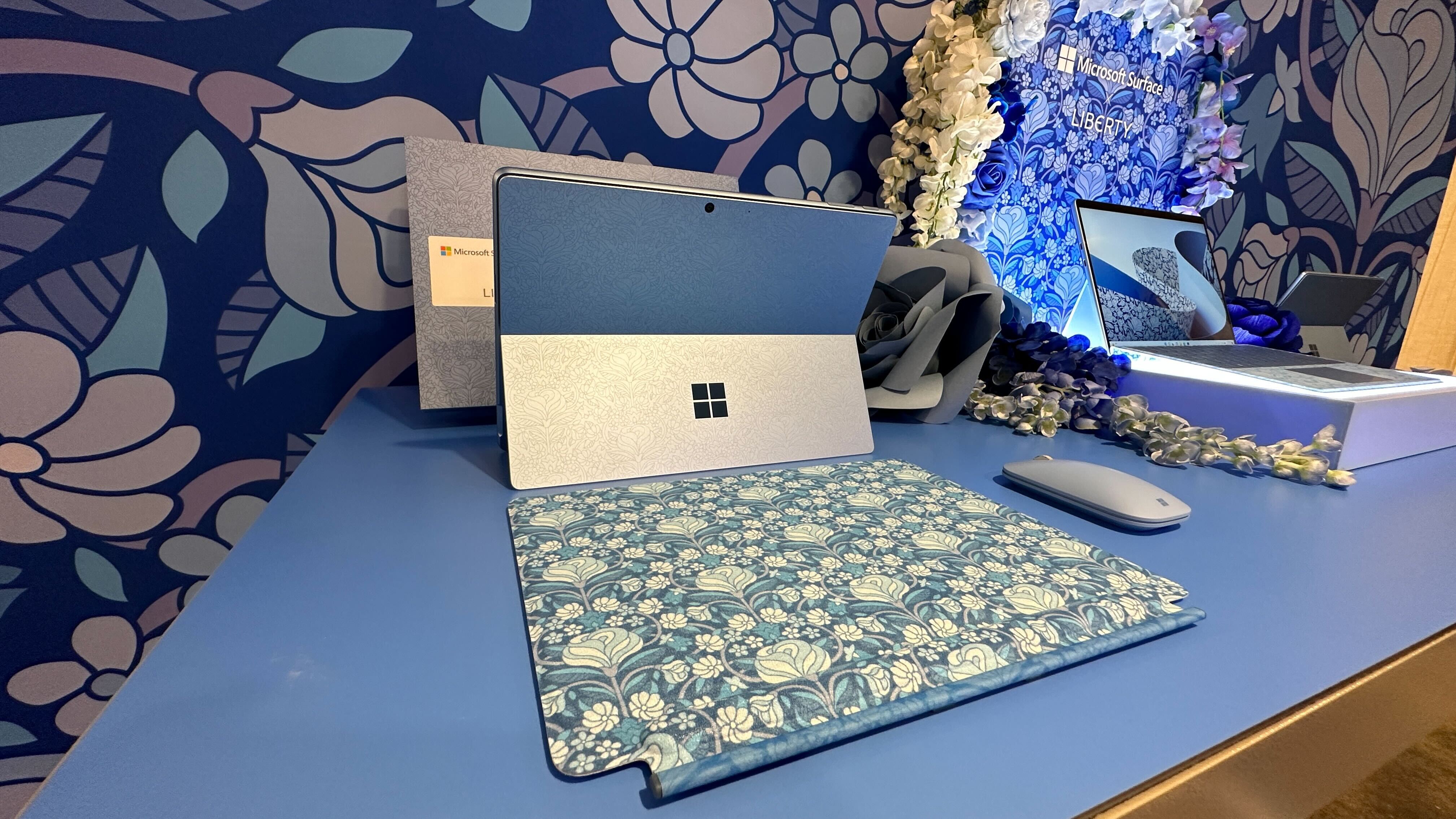 Microsoft Surface X Liberty London collaboration, showing Surface Pro 9 tablet with a blue floral print design.