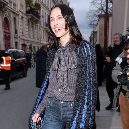 Alexa Chung wears stove pipe jeans with square-toe heels and a tie blouse.