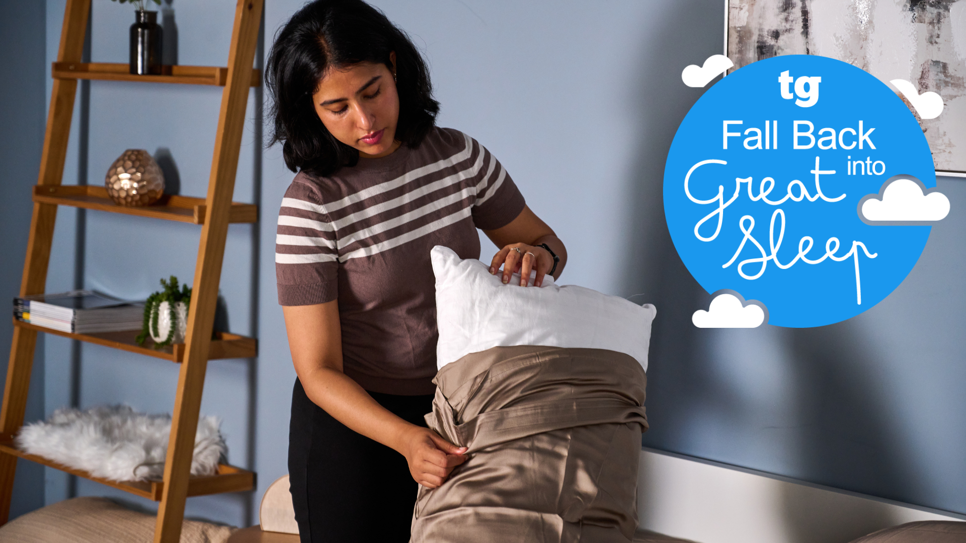 A woman removing the pillow cover in a brightly lit room with the TG Fall Back into Great Sleep campaign badge on the right side 