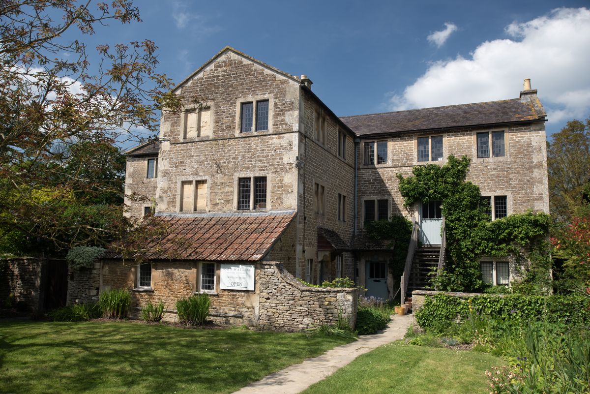 An image of a country home and garden with a blue sky
