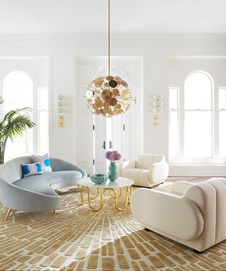 Living room wall lighting ideas by Jonathan Adler using two Lisbon sconce fittings in a luxury space with velvet and boucle sofas