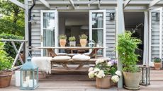 Best balcony plants – outdoor seating area with potted plants