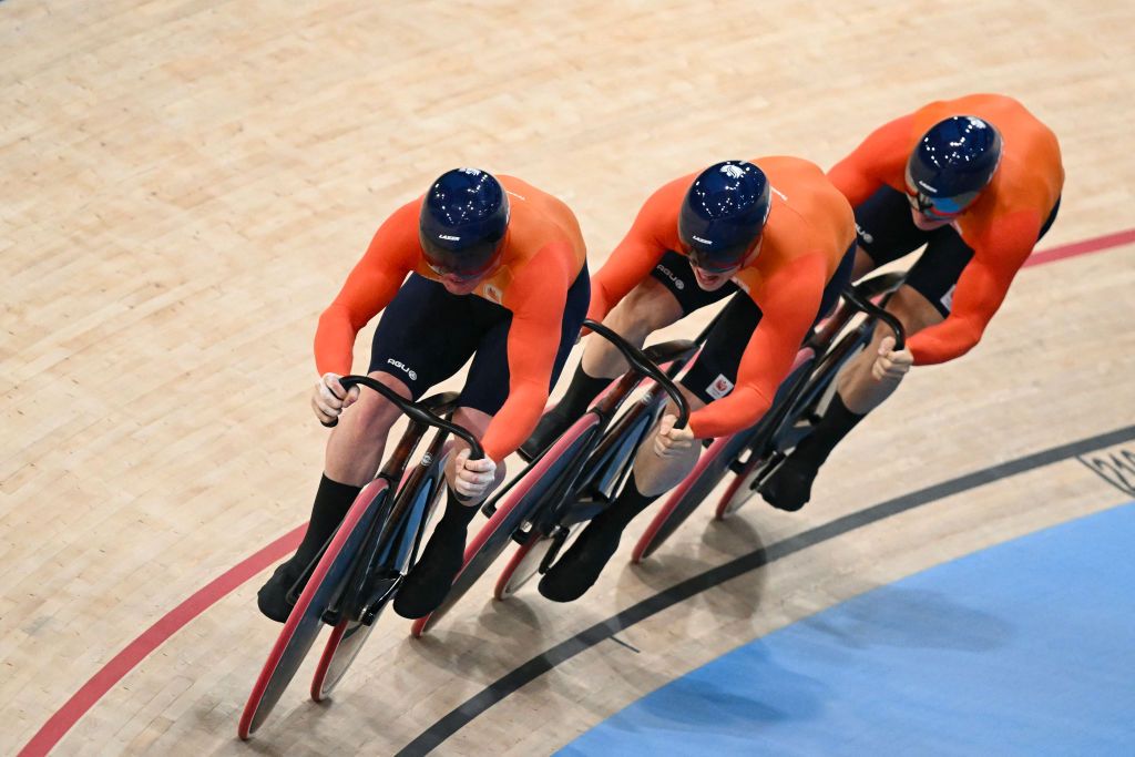 Netherlands' Roy van den Berg, Netherlands' Harrie Lavreysen and Netherlands' Jeffrey Hoogland compete to win the men's track cycling team sprint final for gold of the Paris 2024 Olympic Games at the Saint-Quentin-en-Yvelines National Velodrome in Montigny-le-Bretonneux, south-west of Paris, on August 6, 2024. (Photo by SEBASTIEN BOZON / AFP)