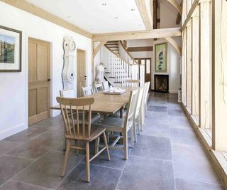 dining hall in oak frame home with slate floor