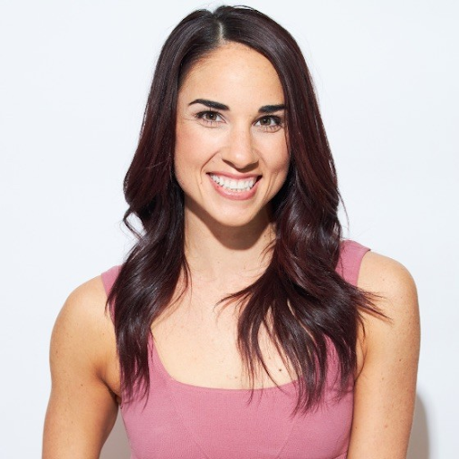 Portrait of smiling woman with dark hair, wearing pink vest