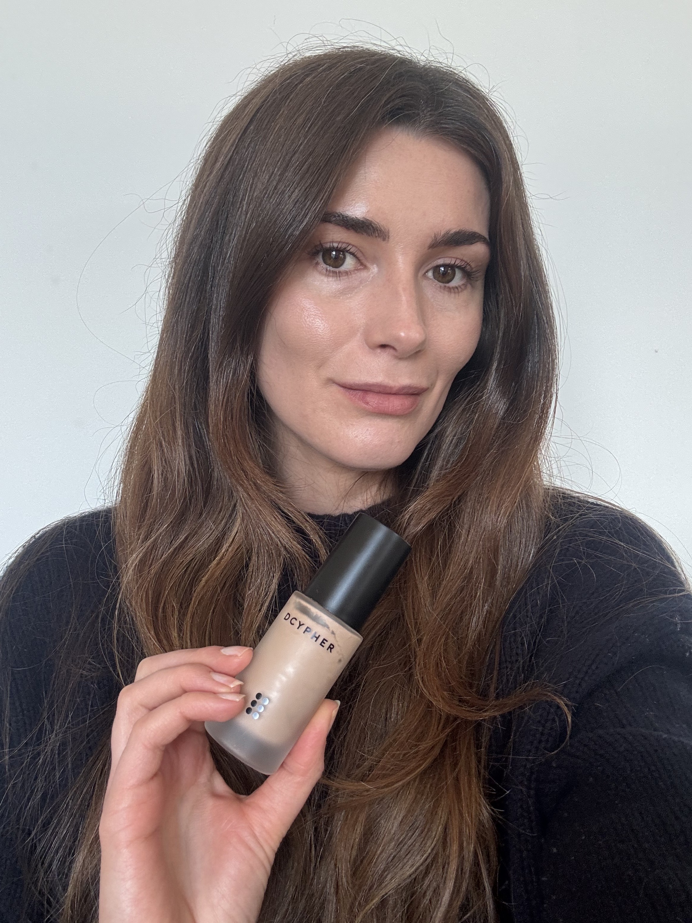 Eleanor holding her bottle of Dcypher foundation