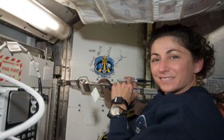 a female astronaut aboard the International Space Station