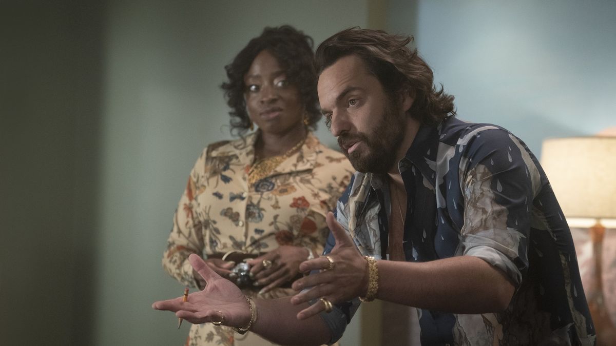 Idara Victor looks at Jake Johnson explaining something in Minx