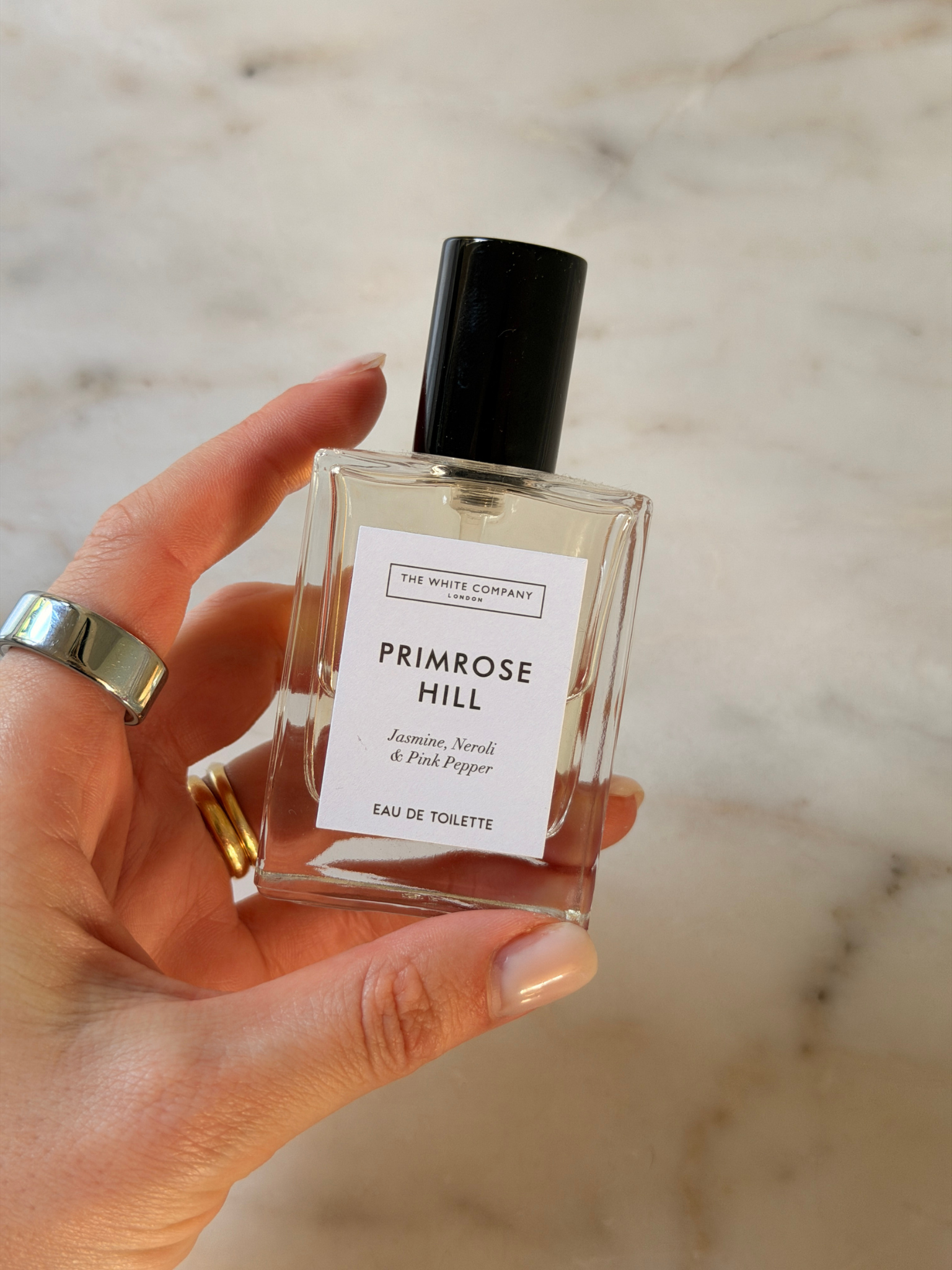 Grace holding a bottle of The White Company perfume