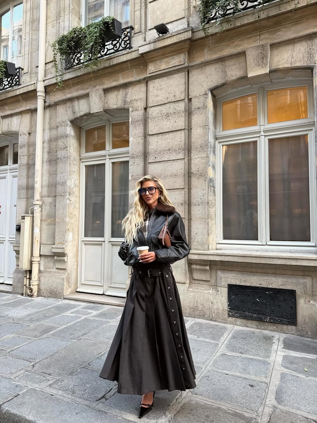 @emilisindlev wears black maxi skirt black leather jacket