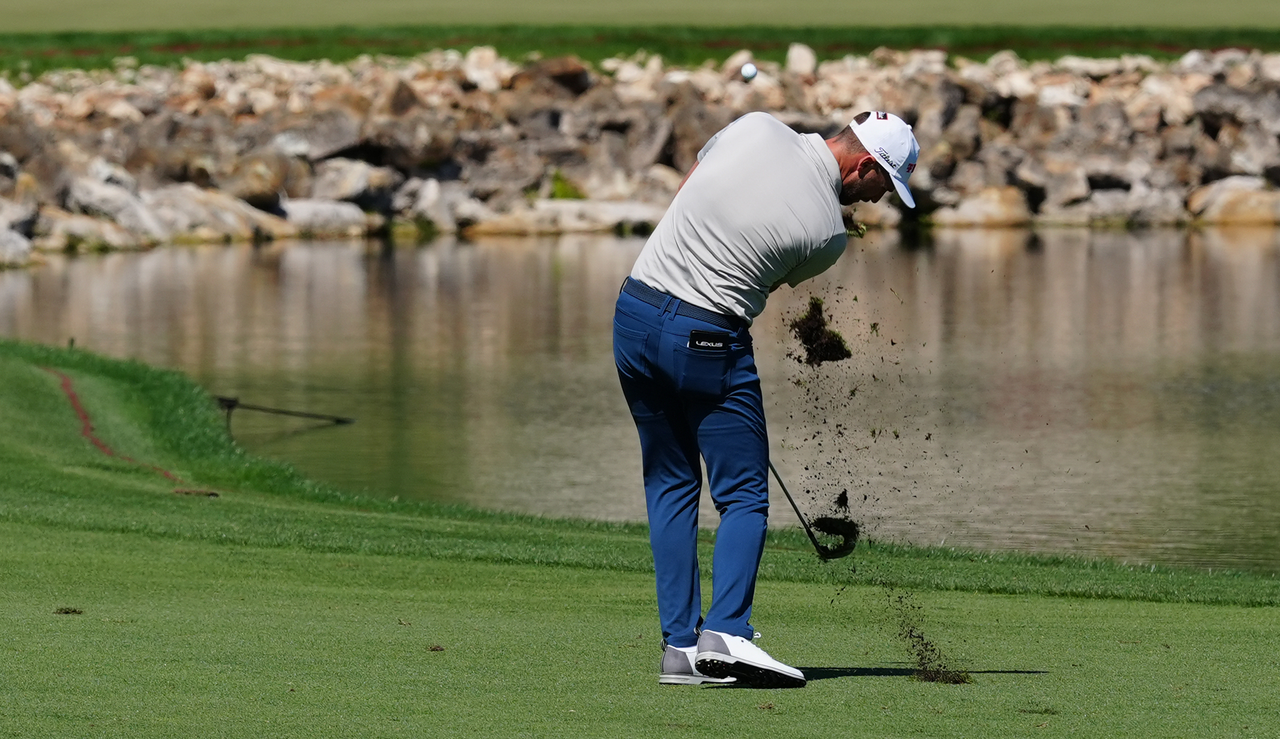 Wyndham Clark strikes an iron from the centre of the fairway