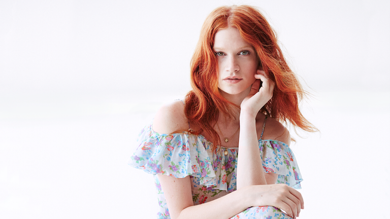 Clothing, Hairstyle, Shoulder, Sitting, Style, Red hair, Dress, Fashion, Beauty, Day dress,