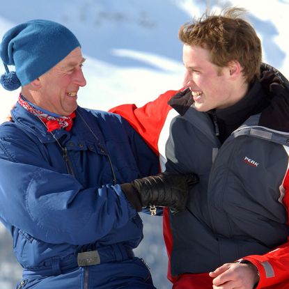 Prince William and King Charles laughing wearing ski gear