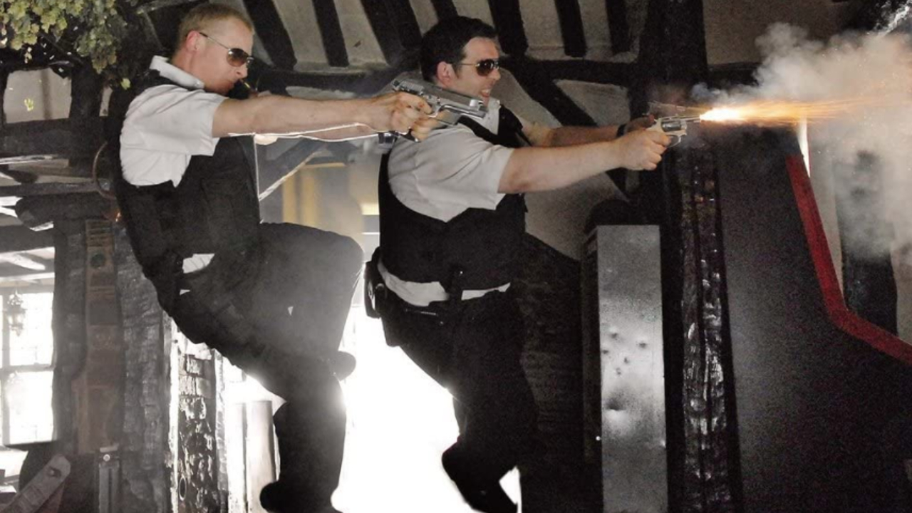 Simon Pegg and Nick Frost firing two guns whilst jumping through the air in Hot Fuzz.