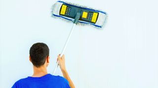 Man mopping a wall