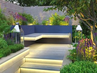 garden decking seating area with steps and lighting