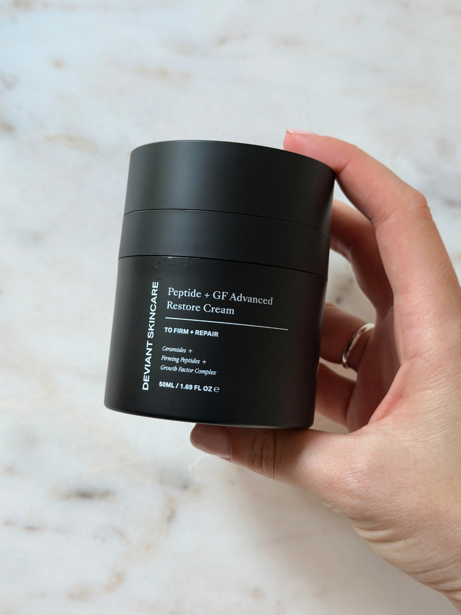 Freelance beauty editor Grace Day holding the Deviant Skincare moisturiser
