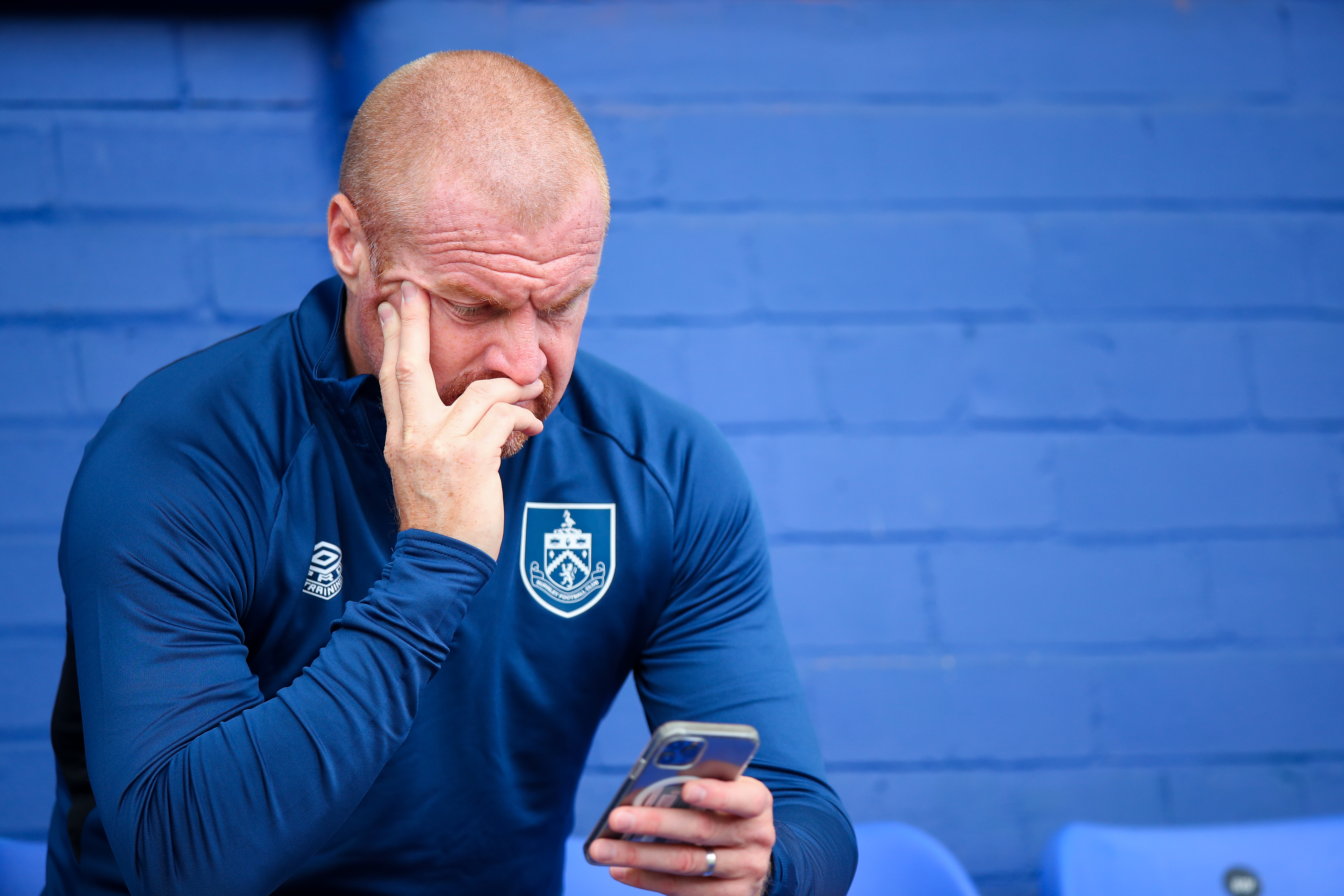 OLDHAM, ENGLAND - JULY 24: Sean Dyche the head coach / manager of Burnley on his mobile phone during the Pre Season Friendly match between Oldham Athletic and Burnley at Boundary Park on July 24, 2021 in Oldham, England. (Photo by Robbie Jay Barratt - AMA/Getty Images)