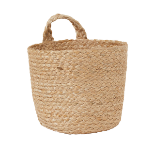 A woven hanging storage basket in natural beige