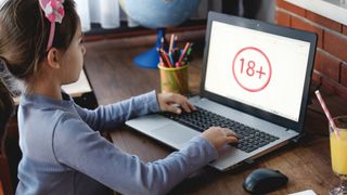 Child on a laptop with 18+ warning