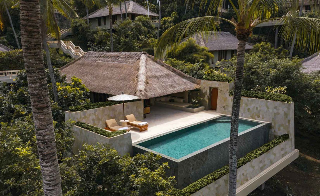 An aerial view of a villa from above showing the pool