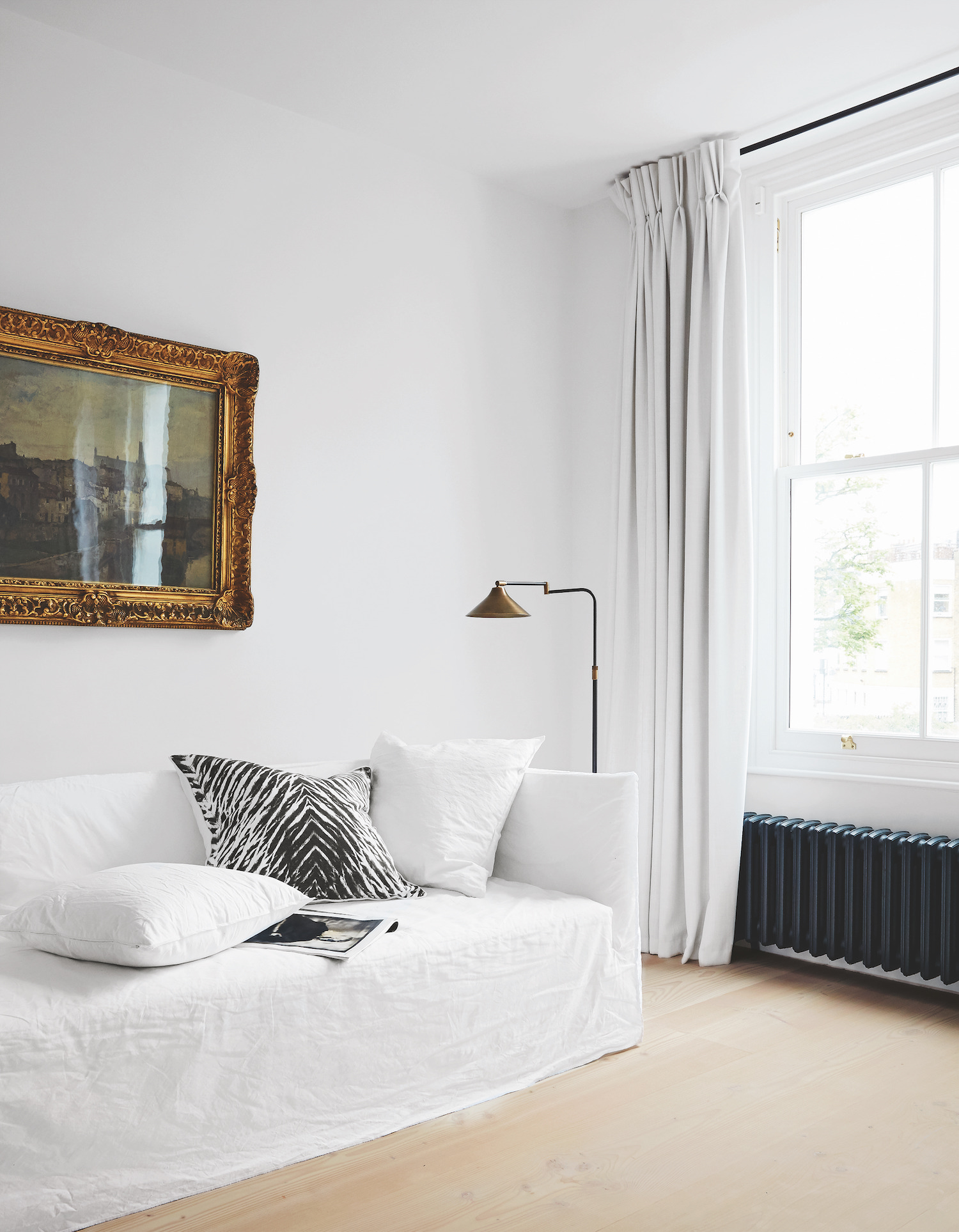 white living room with pinch pleat curtains