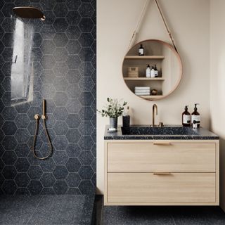 bathroom trends, walk in shower with grey hexagonal tiles, grey tiled floor, floating pale wood and grey vanity, round mirror