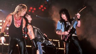 Mick Mars (right) performs onstage with Mötley Crüe