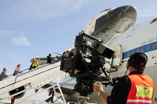 A cameraman shoots the space shuttle Endeavour after its arrival at Los Angeles International Airport on Sept. 21, 2012.