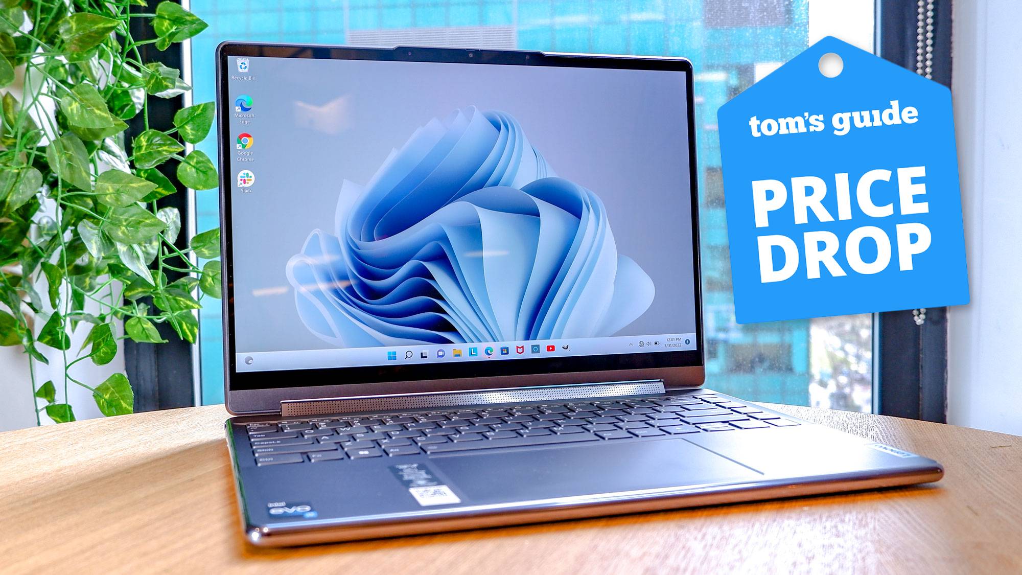 Lenovo Yoga Pro 9i laptop on table with Tom&#039;s Guide Price Drop badge