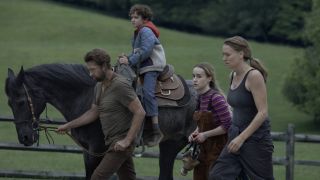 James, Arlo, Merrill and Maggie walking with horse in Teacup