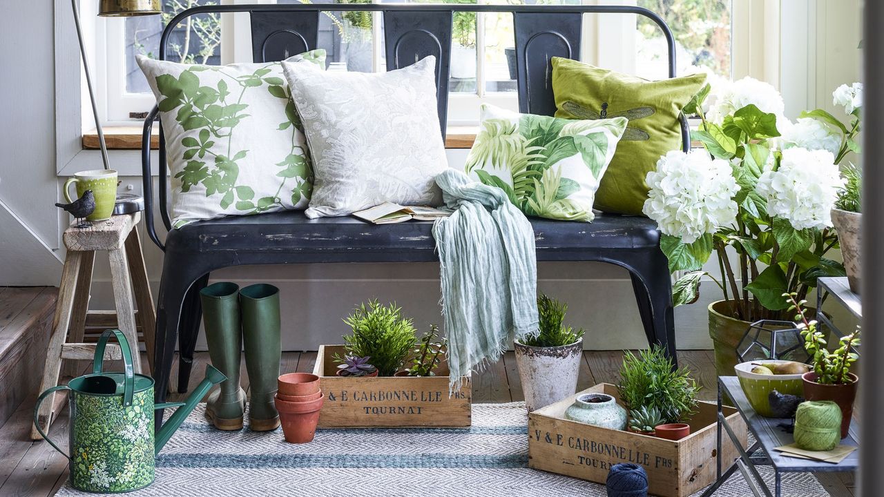 entryway area with iron bench and plants