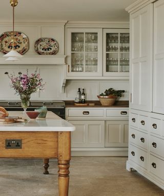 Neutral Artichoke kitchen with glazed wall cabinets filled with glassware