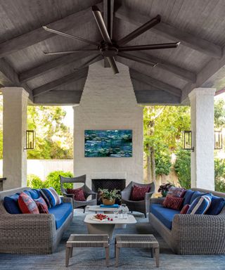outdoor living room space with large fireplace