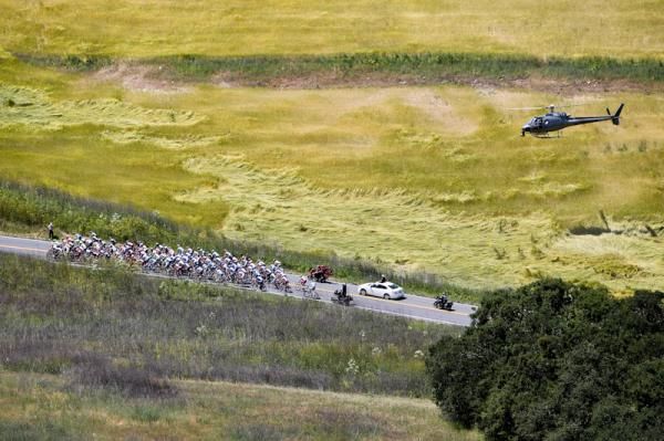 A helicopter flying above the peloton on the road to Paso Robles
