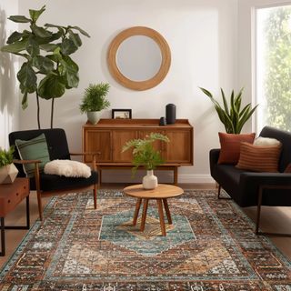 KUETH Area Rug on the floor surrounded by armchairs and a wooden dresser. 