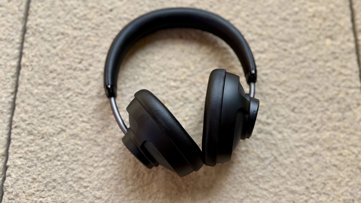 The jlab jbuds open headphones on a stone surface