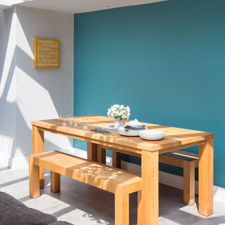 dining area with blue wall and dining table
