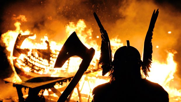 The Guizer Jarl or Chief of the Jarl viking squad is silhoutted by a burning viking longship during the annual Up Helly Aa Festival, Lerwick, Shetland Islands, January 26, 2010. Up Helly Aa c