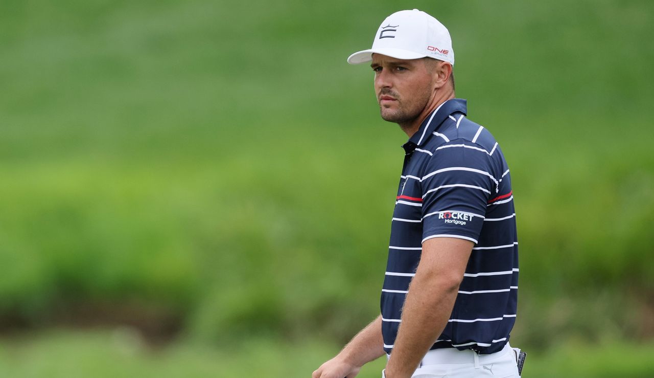 Bryson DeChambeau looks on whilst waiting to putt on the green