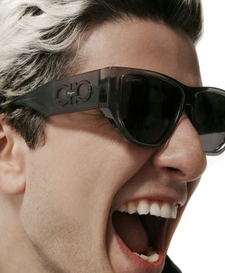 Man in Salvatore Ferragamo sunglasses with mouth open