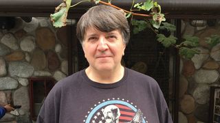Leonardo Pavkovic from MoonJune Records in a garden wearing a Tony Levin t-shirt