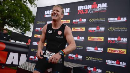 Gordon Ramsay smiles after completing an Ironman competition