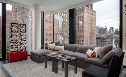 Interiors at Peter Marino’s unique Getty apartments with grey sofa and carpet