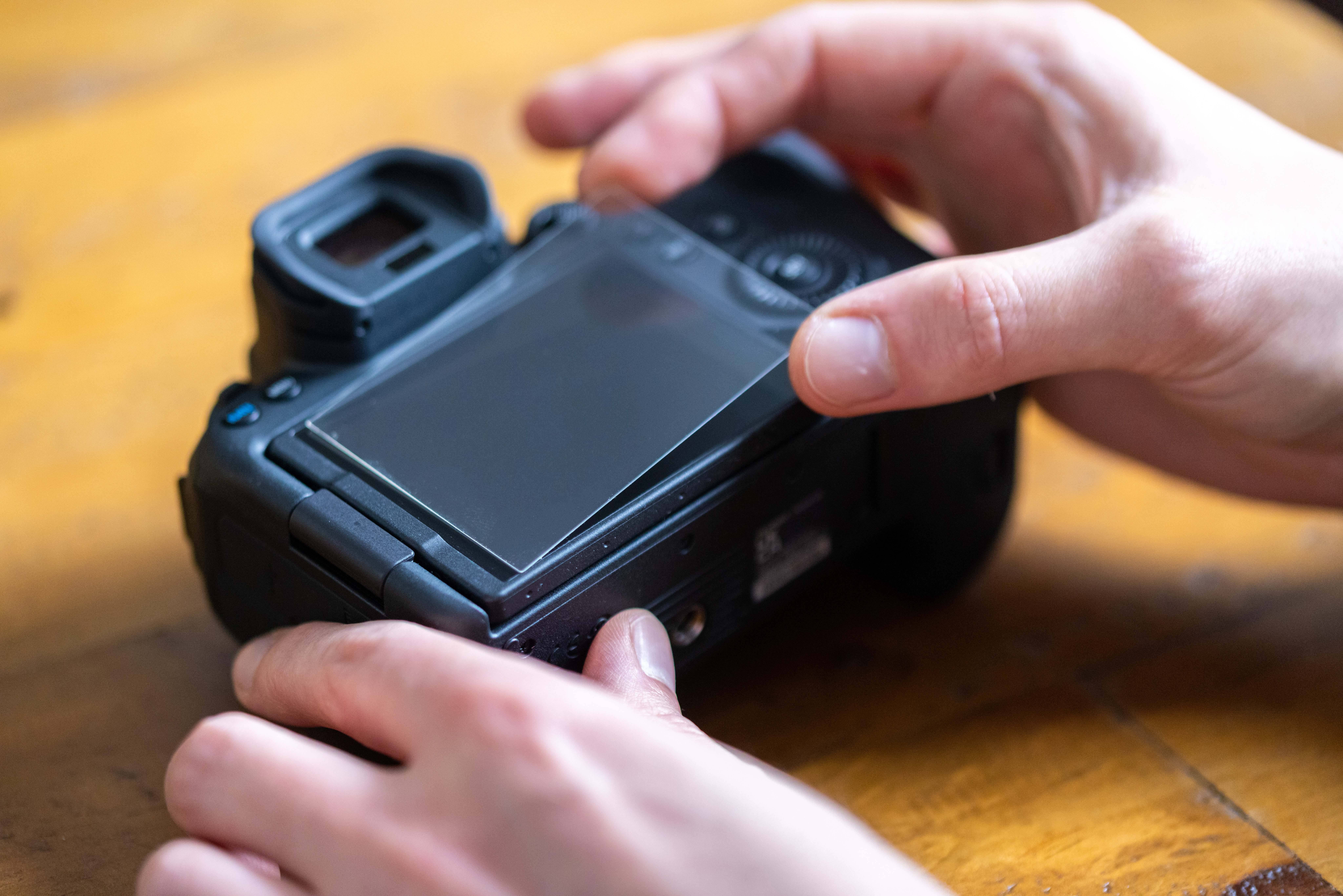 A screen protector being applied to the rear screen on a Canon EOS R6 Mark II