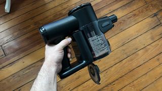 A hand holding the Ecovacs Deebot T30S Combo's handheld vacuum