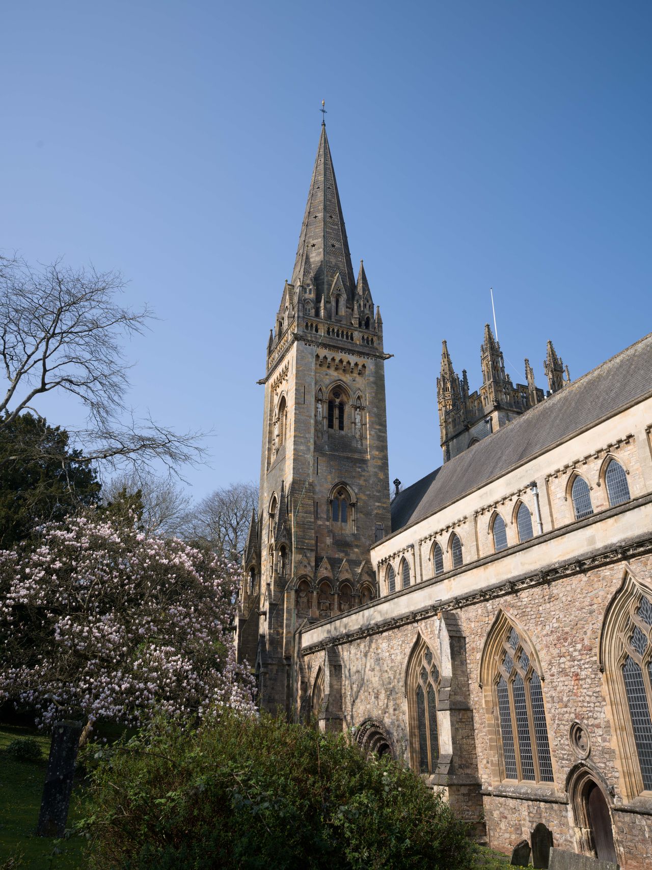 A photo of a cathedral steeple against a blue sky