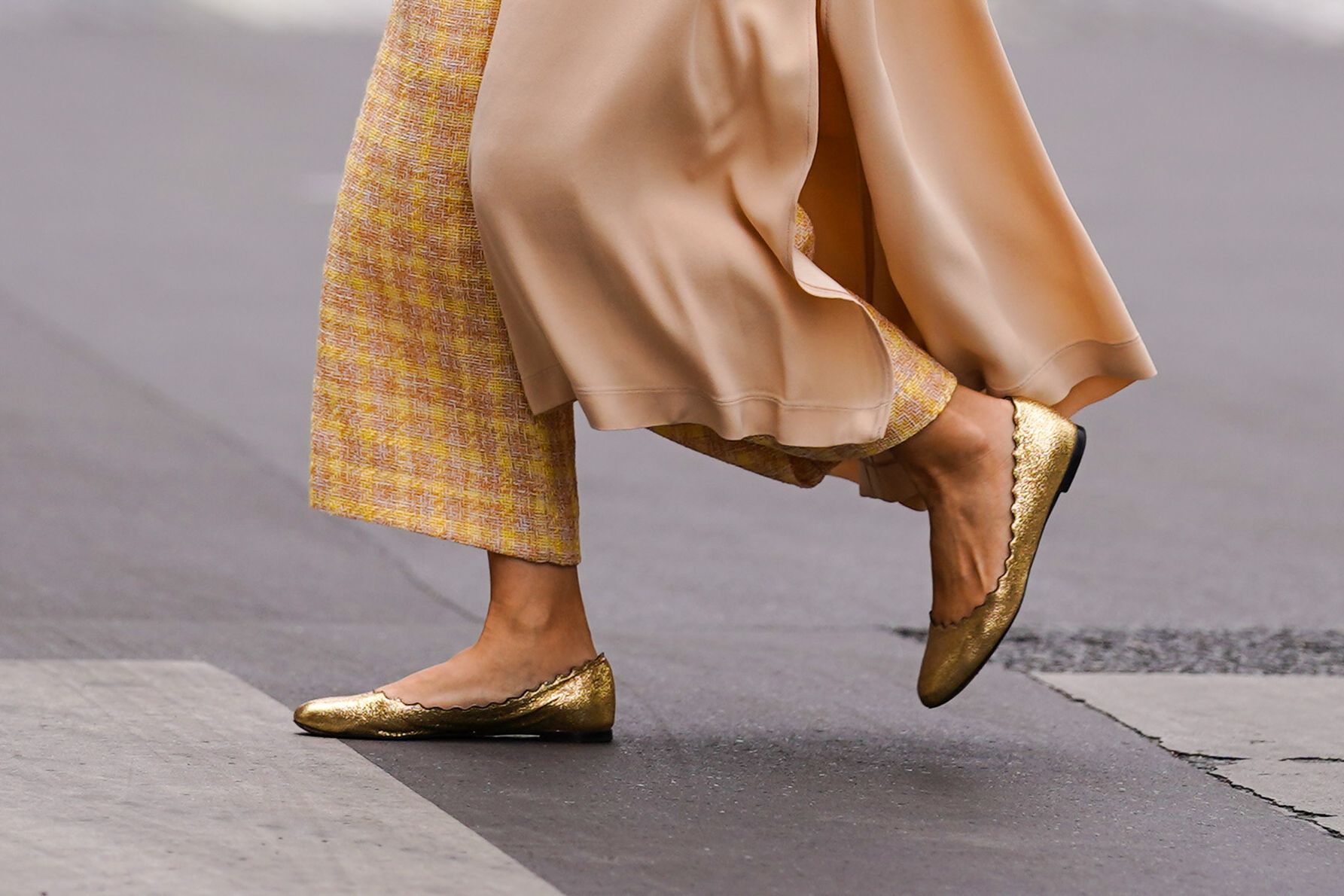 woman in gold ballet flats