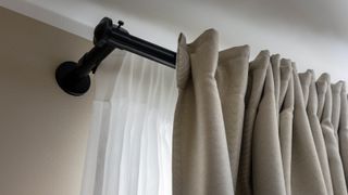 A thick rail holding up curtains